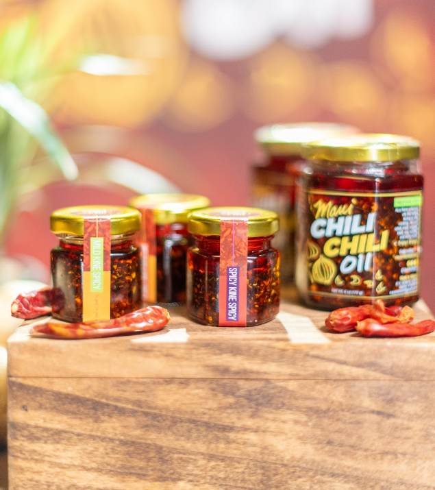 mini jars and 6oz jar of chili oil on a wooden display