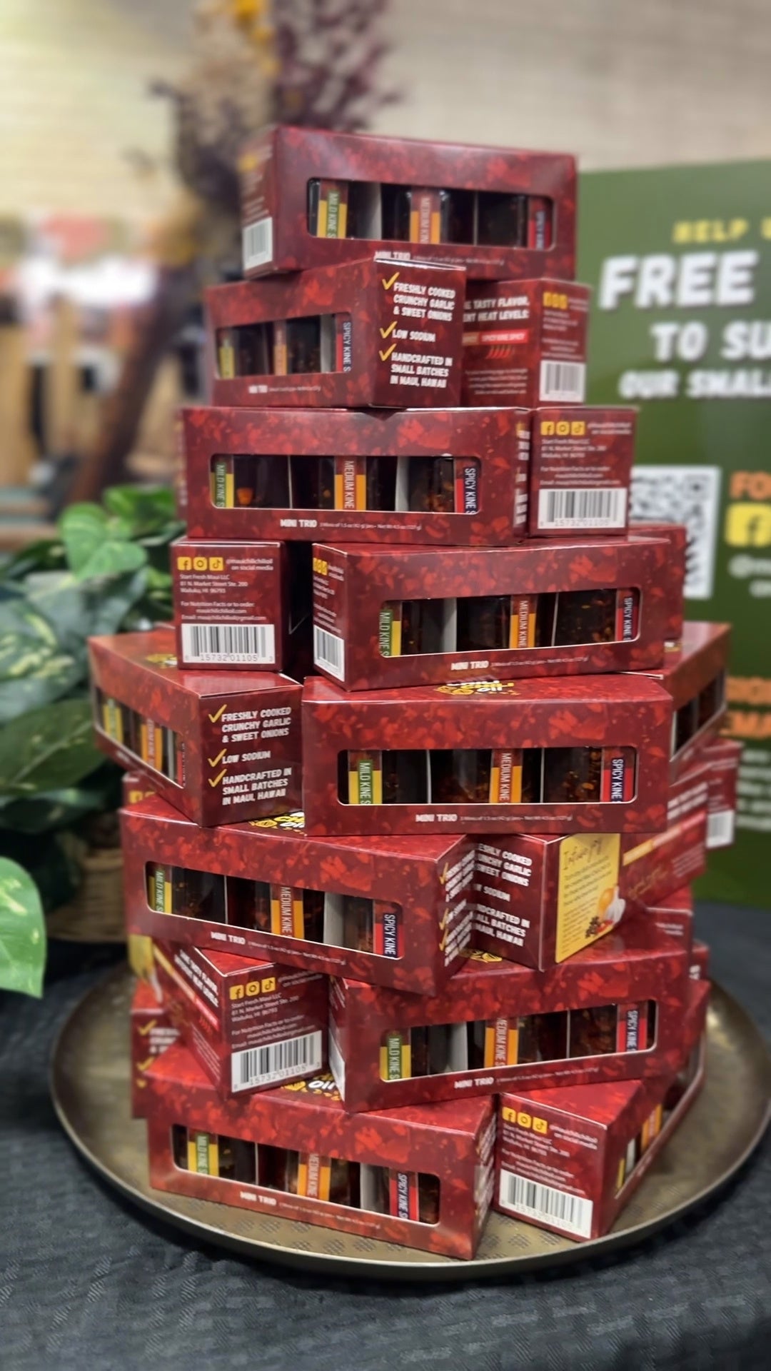 Stack of red boxes on a metal tray with a blurred background